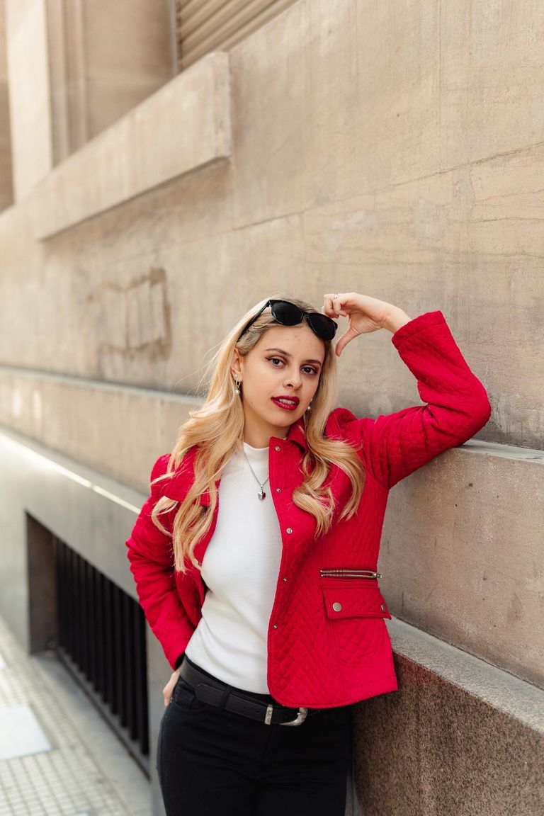 Martina con chaqueta roja y una mano sobre las gafas.